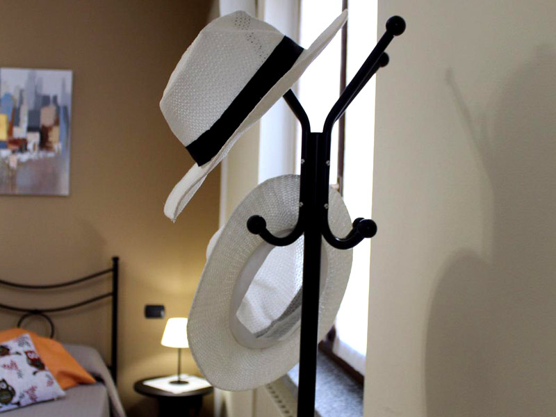 Dettaglio d'arredo con cappelli nella camera di Casa Giardini